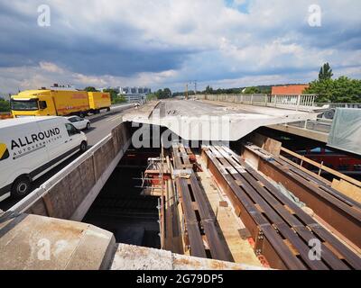 12. Juli 2021, Brandenburg, Potsdam: Auf der Baustelle der Hochbrücke der Landstraße L40 Nuthestraße wurden für die Segmente der alten Brücke Transportschienen aus Stahl verlegt. Aufgrund von Platzmangel werden die rund 30 Meter langen und 600 Tonnen schweren Abschnitte aus Beton und Stahlverstärkung in mehreren Teilschritten hinter dem Abutment der Friedrich-Engels-Straße hydraulisch auf die Schienen gezogen, wo der alte Überbau zerkleinert und abtransportiert wird. Die Sanierung der Hochstraßenbrücke soll im Oktober 2022 abgeschlossen sein. Foto: So Stockfoto