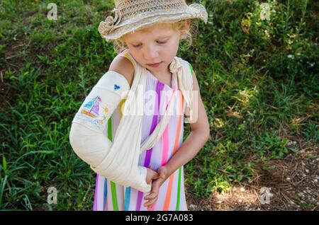 Schönes Mädchen mit gebrochener Hand und Bild in den Gips gezeichnet Stockfoto