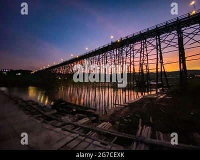 Mon Bridge, alte Holzbrücke bei Sonnenuntergang in Sangkhlaburi, Kanchanaburi, Thailand Stockfoto