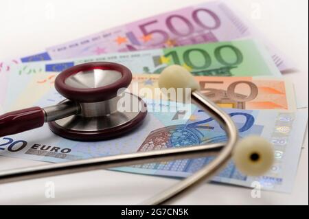 Kosten und Einnahmen im Gesundheitssektor mit Euro-Banknoten und Stethoskop Stockfoto