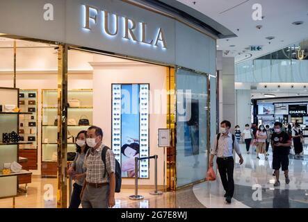 Shopper laufen am italienischen Mode-Luxusladen Furla in Hongkong vorbei. Stockfoto
