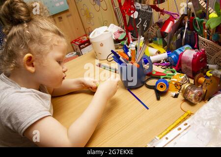 Ein kleines Mädchen ist begeistert von der Kreativität der Kinder. Konzept der Vorschulbildung. Stockfoto