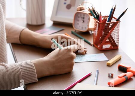 Frau Färbung Lesezeichen am Tisch, Nahaufnahme Stockfoto