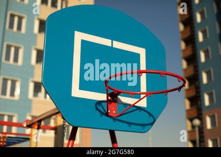 Basketballkorb auf dem Sportplatz. Kugelring. Sportgeräte im Hof. Basketball auf der Straße. Stockfoto