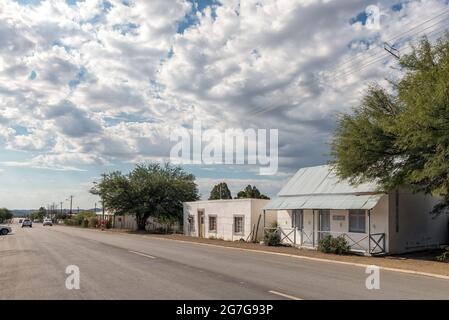 PRINCE ALBERT, SÜDAFRIKA - 20. APRIL 2021: Eine Straßenszene mit der Hauptstraße und den Häusern in Prince Albert in der Westkap-Provinz. Fahrzeuge Stockfoto