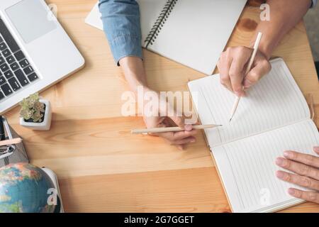 Tutor Bücher mit Freunden, junge Studenten Campus oder Mitschüler hilft Freund aufholen Arbeitsbuch und lernen Nachhilfe im Klassenzimmer, Lehre, Lernen Stockfoto