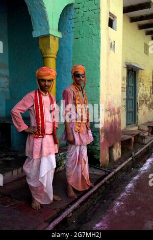 Eifrige Anhänger versammeln sich während Lathmar Holi am Krishna-Tempel von Shriji. Männer von Barsanaüberfallen die Stadt, während sie mit farbigen Wassersprühen angegriffen werden Stockfoto