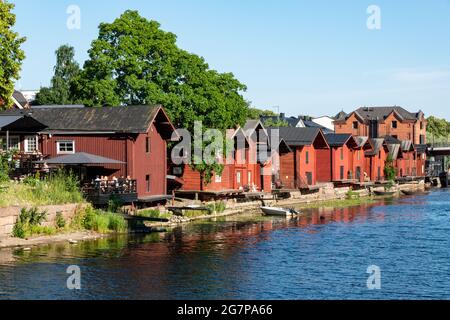Alte hölzerne rote ockerfarbene Lagergebäude am Fluss Porvoonjoki in der Altstadt von Porvoo, Finnland Stockfoto