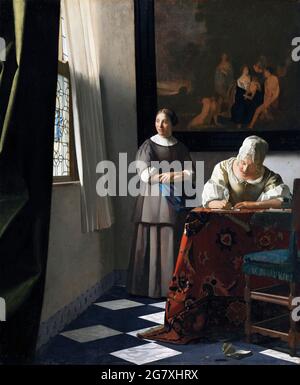 Frau schreibt einen Brief mit ihrer Jungfrau von Johannes Vermeer (1632-1675), Öl auf Leinwand, c. 1670 Stockfoto