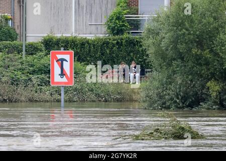 Hattingen, NRW, Deutschland. Juli 2021. Die Menschen sitzen am Rande des neu ausgebauten Flusses. Die Ruhr hat ihre Böschung, Felder und viele Gärten, Keller und Grundstücke in der Nähe der Stadt Hattingen im Ruhrgebiet in Nordrhein-Westfalen überflutet. NRW ist nach starken Regenfällen in den letzten Tagen von schrecklichen Überschwemmungen heimgesucht worden. Bei den Überschwemmungen in Deutschland sind bisher mehr als 80 Menschen ums Leben gekommen. Kredit: Imageplotter/Alamy Live Nachrichten Stockfoto