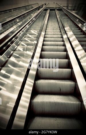 Rolltreppe im Bürogebäude leer von allen Menschen, starke Perspektivlinien, Blick nach oben. Stockfoto