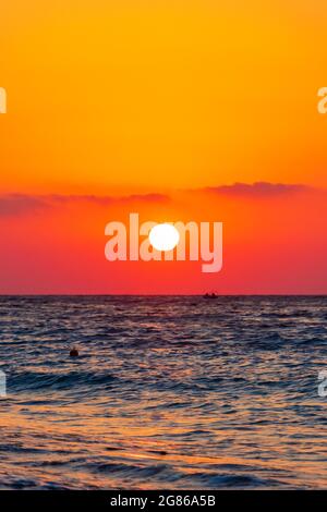 Regenbogenfarben des schönsten Sonnenuntergangs am Strand von Ialysos auf der griechischen Insel Rhodos. Stockfoto