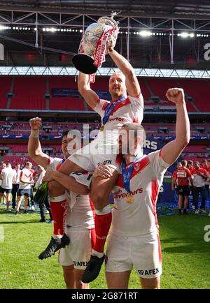 James Roby von St. Helens (Mitte) hält die Trophäe und feiert mit den Teamkollegen Louie McCarthy-Scarsbrook (links) und Kyle Amor nach dem finalen Spiel des Betfred Challenge Cup im Wembley Stadium, London. Bilddatum: Samstag, 17. Juli 2021. Stockfoto
