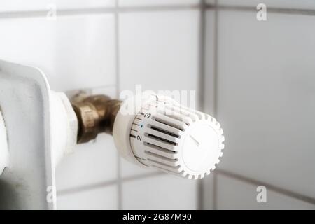 Ein älterer Thermostat auf einem veralteten Heizgerät verursacht hohe Heizkosten, insbesondere wenn die Energiepreise steigen, Platz kopieren, Fokus auswählen, enge Tiefe von Stockfoto