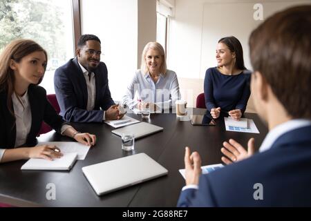 Mentor, Coach im Gespräch mit Mitarbeitern, Schulung, Besprechung von Marketingberichten Stockfoto