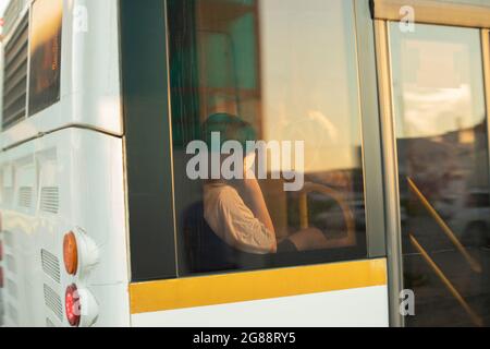 Das Mädchen schläft vor dem Busfenster. Frau im Transport. Der Mann vor dem Fenster. Stockfoto