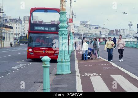 Farbenfrohe Doppeldecker-Reisebusse warten an den Bushaltestellen, um Passagiere für ihre Fahrten entlang der Küste von Brighton nach Eastbourne abzuholen Stockfoto