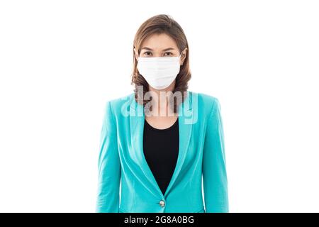 Mittelalter schöne Geschäftsfrau in legerer Business-Kleidung trägt medizinische Hygiene Schutzmaske isoliert auf weißem Hintergrund und schauen zu CAM Stockfoto