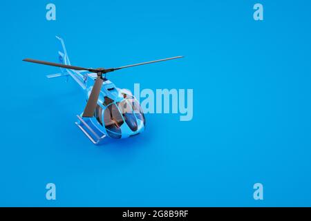 3D-Grafiken, Modell eines blauen Hubschraubers. Blauer Hubschrauber auf farbigem Hintergrund. Computergrafiken. Isolierter Hubschrauber auf blauem Hintergrund. Stockfoto