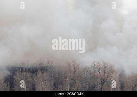 Rauch aus einem Brand in einer Textilfabrik, die Ende des 19. Jahrhunderts erbaut wurde. Nevskaya Manufactra in St. Petersburg, 12. April 2021. Stockfoto