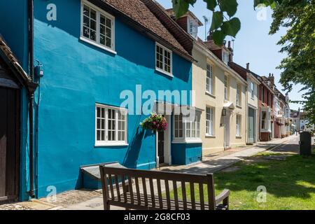 Farbenfrohe Reihenhäuser in Alresford, einer kleinen georgianischen Stadt in Hampshire, England, Großbritannien. Blick auf die Broad Street. Stockfoto