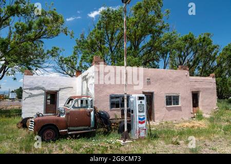 La Jara, Colorado, EIN rostiger, alter Pickup-Truck, der vor einer alten Chevron-Tankstelle im Süden Colorados geparkt ist. Stockfoto