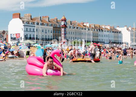 Überfülltes Meer in Weymouth. Touristen genießen heißes Wetter Stockfoto