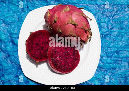 Exotische Früchte genannt Drachenfrucht, Kaktus pitahaya rote Farbe mit ganzen reifen serviert und in Scheiben geschnitten gehackt. Einzigartige verschiedene Früchte in indien Asien gekauft Stockfoto