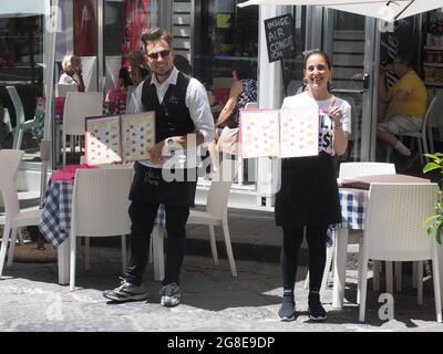 Kellnerin und Kellner zeigen Menü vor einem Eiscafe, Ercolaneo, Kalabrien, Italien Stockfoto