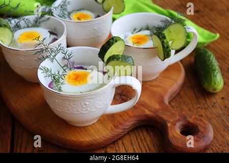 Kalte Suppe mit Gurken, Joghurt und frischen Kräutern auf dem rustikalen Holztisch Stockfoto