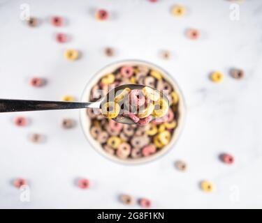 Coloful Cerealien-Frühstücksringe in einer Schüssel mit Löffel schlingern Stockfoto