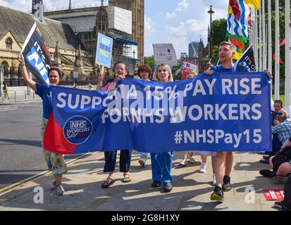 London, Großbritannien. Juli 2021. Demonstranten marschieren und halten ein Banner mit der Forderung nach einer 15%igen Gehaltserhöhung für NHS-Beschäftigte während der Demonstration auf dem Parliament Square.Gewerkschaftsmitglieder, NHS-Beschäftigte und Unterstützer versammelten sich in Westminster, um eine Gehaltserhöhung von 15% für alle NHS-Beschäftigten zu fordern, nachdem die Regierung eine Erhöhung um 1% vorgeschlagen hatte. Und marschierten zur Downing Street 10, um ihre Petition zu überbringen. Kredit: SOPA Images Limited/Alamy Live Nachrichten Stockfoto