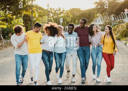 Diverse Freunde umarmen und gehen auf der Straße Stockfoto