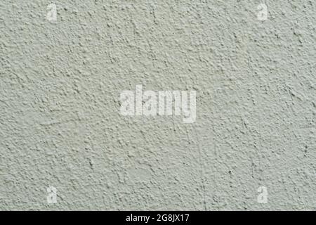 Textur der lackierten hellgrünen Betonwand. Stuckwand Nahaufnahme, Hintergrund Stockfoto