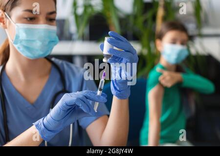 Krankenschwester Mit Spritze, Die Die Dosis Des Covid-19-Impfstoffs Aus Dem Fläschchen Einnahm Stockfoto