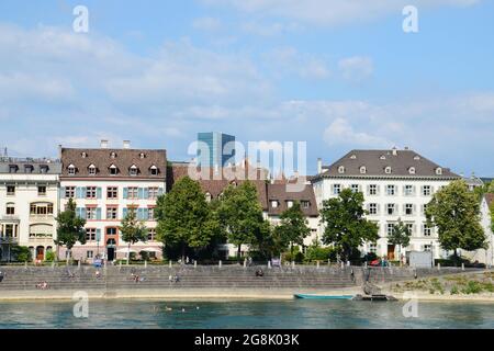 Die Einheimischen hängen am Ufer des Rheins und schwimmen in Basel, Schweiz Stockfoto