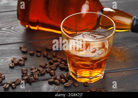 Whiskey oder Likör, Kaffeebohnen und Orange auf Holzgrund geschnitten. Saisonales Urlaubskonzept. Stockfoto