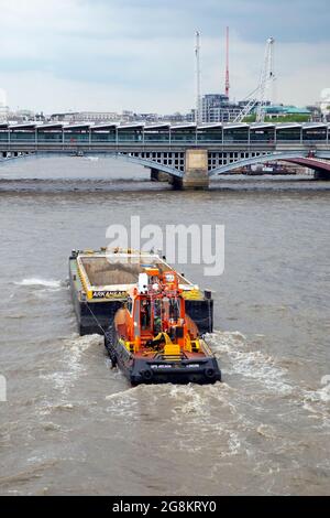 GPS Arcadia Schlepper auf der Themse schiebt Arkansas Barge in London England Großbritannien KATHY DEWITT Stockfoto