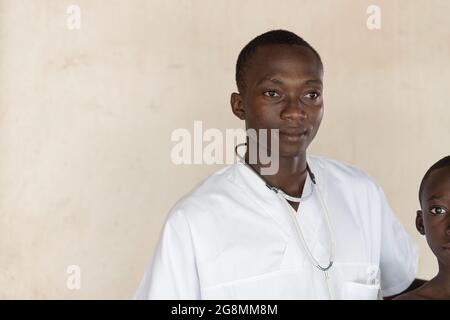 Dies ist ein Bild eines einheimischen afrikanischen Arztes, der im Freien in einem ländlichen Dorf in der Nähe von Bamako, Mali, posiert. Stockfoto