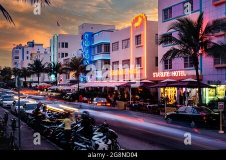 Hotels und Verkehr auf dem Ocean Drive bei Sonnenuntergang, South Beach, Miami, Florida, USA Stockfoto