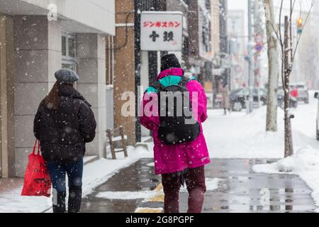 Sapporo, Japan-December 26,2017: Straßenansicht des Sapporo Stadtzentrums während der Wintersaison mit schneebedeckter Straße Stockfoto