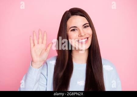 Foto von schönen optimistisch lange Frisur Brünette Dame Welle Hand tragen blauen Pullover auf pastellrosa Farbe Hintergrund isoliert Stockfoto