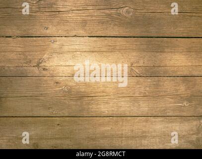 Hintergrund wie alte Bretter einer rustikalen Holzwand. Die hölzerne Wand aus dem Dorf des letzten Jahrhunderts. Stockfoto