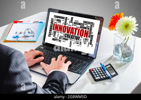 Mann tippt auf einem Laptop und zeigt ein Konzept für das Innovationswort „Cloud“ an Stockfoto