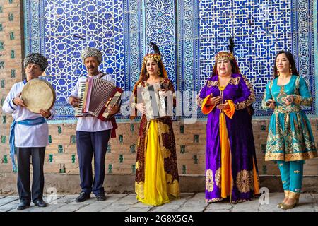 Khorezmische Musiker im lokalen Kleidungstanz, in Chiwa, Usbekistan. Stockfoto