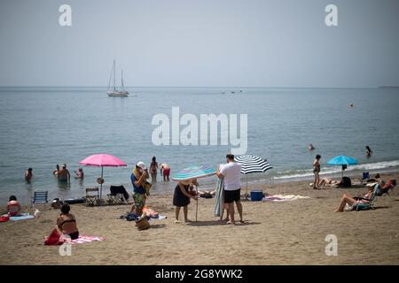 Malaga, Spanien. Juli 2021. Badegäste werden während eines heißen Sommertages inmitten einer Coronavirus-Pandemie am Strand von Malagueta beim Sonnenbaden beobachtet.die staatliche Wetteragentur AEMET sagte, dass die Temperaturen am nächsten Tag in Andalusien mit mehr als 40º Grad in Malaga und anderen Provinzen steigen werden. Viele Badegäste werden erwartet, an den Stränden anzukommen, um sich zu sonnen und die sonnigen Tage zu genießen. (Foto von Jesus Merida/SOPA Images/Sipa USA) Quelle: SIPA USA/Alamy Live News Stockfoto