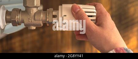 Hand, die Temperatur mit Thermostat eines Heizkörpers zu Hause, Banner Stockfoto