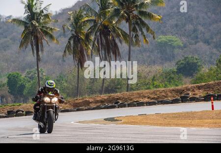 Mann trainiert mit seinem Motorrad auf der Rennstrecke Runden Stockfoto