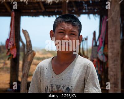 Uribia, La Guajira, Kolumbien - 28 2021. Mai: Porträt eines Wayuu-Jungen, der an einem sonnigen Tag die Kamera anschaut Stockfoto