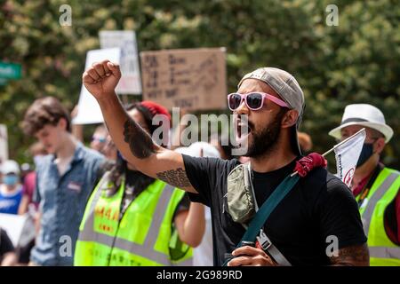 Washington, DC, USA, 24. Juli 2021. Im Bild: Ein Protestler hebt seine Faust, während er während des DC Marsches für Medicare for All mit der Menge singt. Der marsch ist Teil einer landesweiten Nachfrage nach universeller Gesundheitsversorgung mit Veranstaltungen in 56 Städten. Kredit: Allison Bailey / Alamy Live Nachrichten Stockfoto